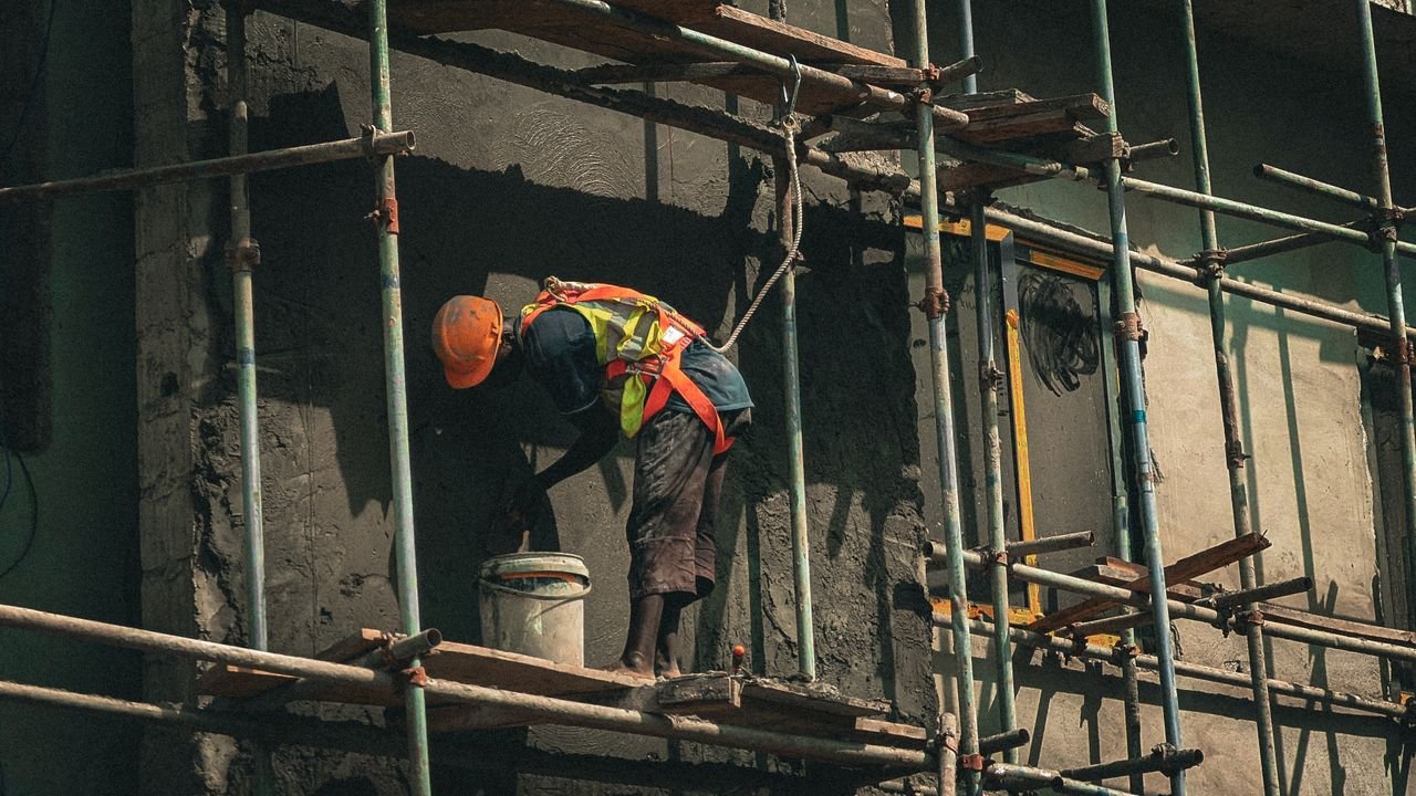 The Art of Drawing Readers In: Your attractive post title goes here A construction worker applies plaster on a building facade in Abuja, Nigeria.